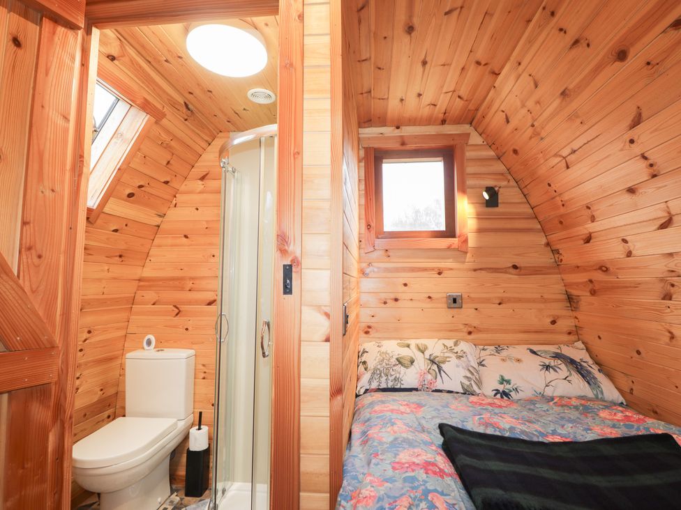 A bedroom with a bed and an attached bathroom at Pod 1