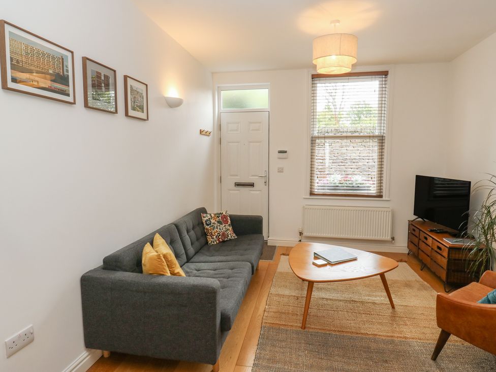 A living room with a sofa and television at Potter’s Cottage in Fulwood near Sheffield