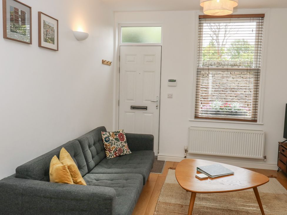 A living room with a sofa and table at Potter’s Cottage Fulwood near Sheffield