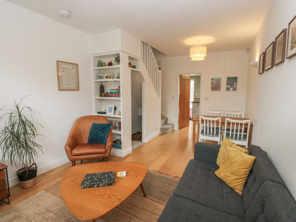 A living room with a sofa and a dining table at Potter’s Cottage Fulwood near Sheffield