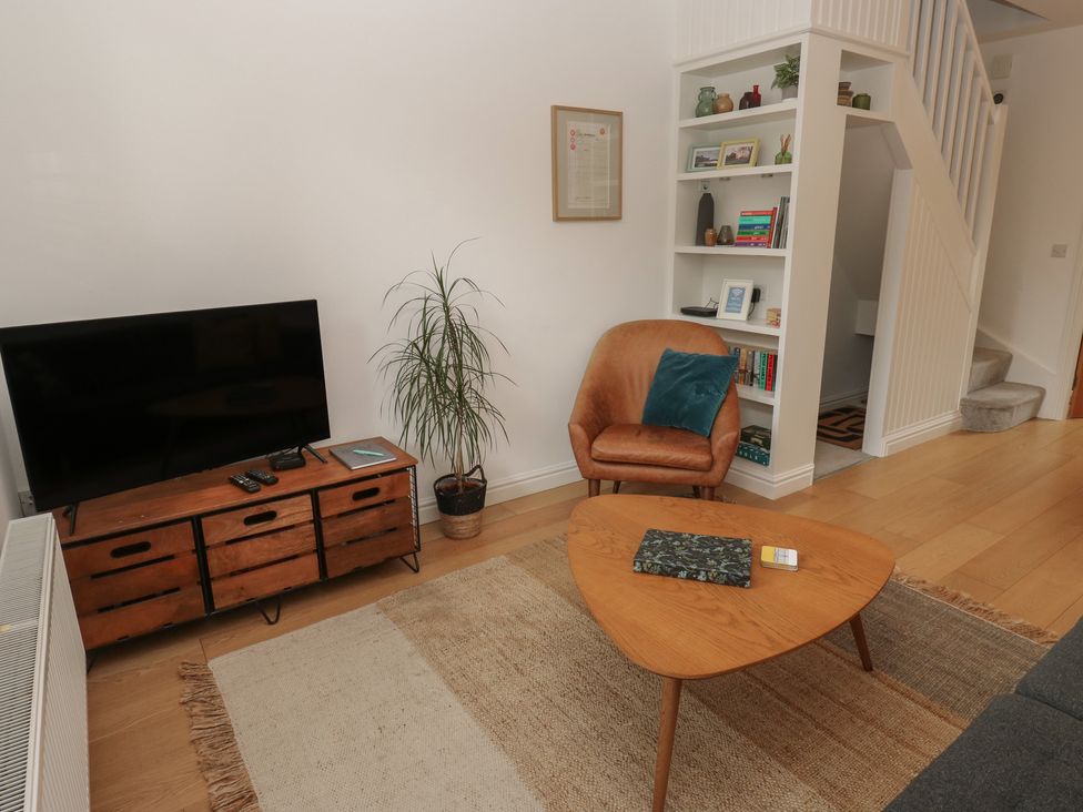A living room with a television and a coffee table at Potter’s Cottage Fulwood near Sheffield