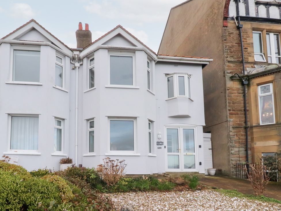 A house exterior with windows and a door at 480 Marine Road East in Morecambe