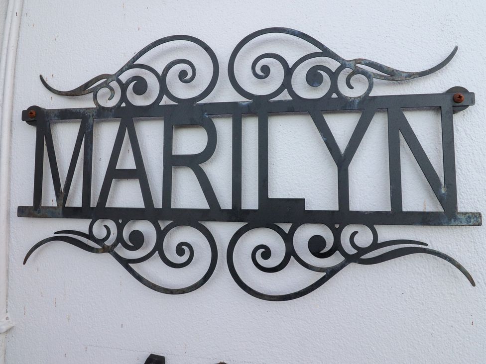 A metal decorative sign with the name MARILYN on a wall at 480 Marine Road East in Morecambe