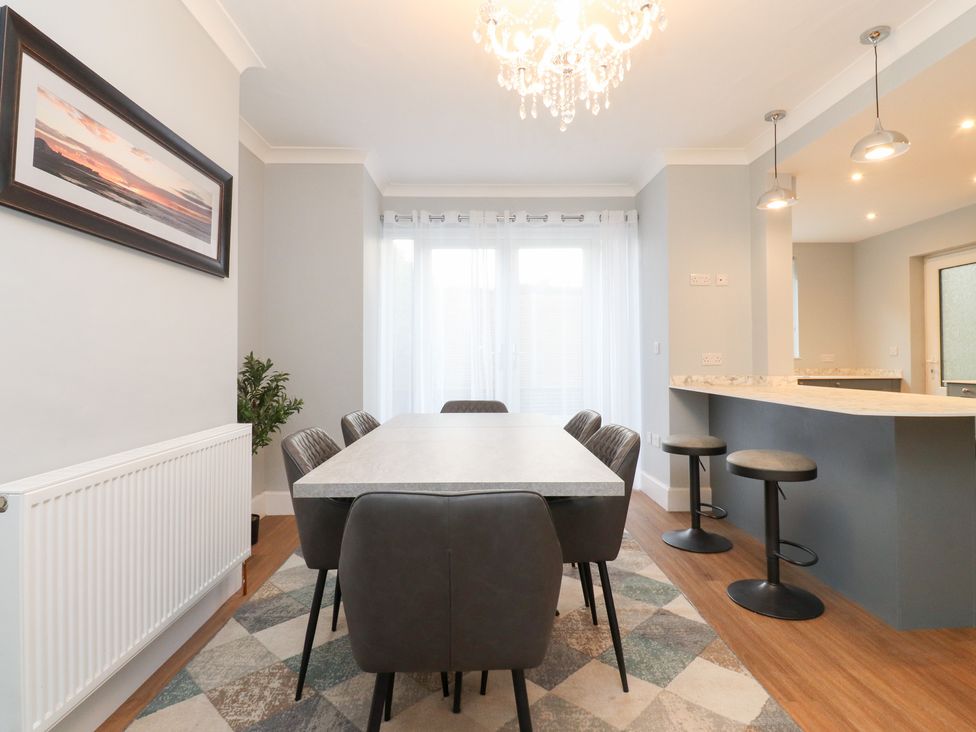 A dining room with a table and chairs at 480 Marine Road East Morecambe