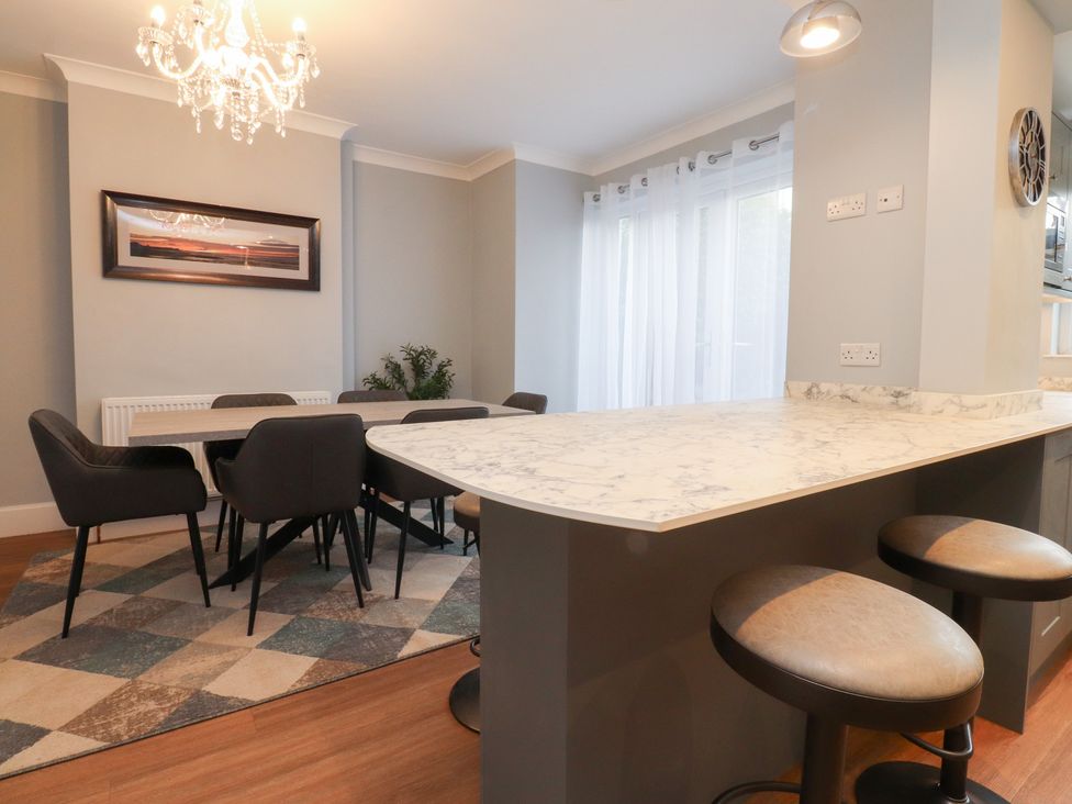 A dining room with a table and chairs at 480 Marine Road East Morecambe