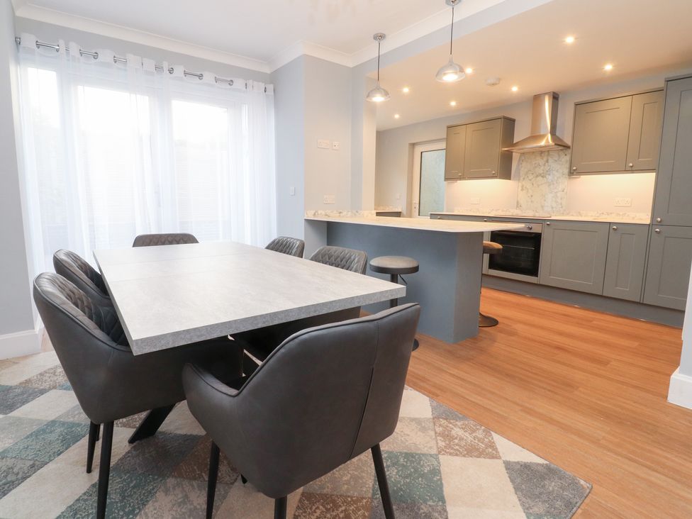 A dining room with a table and chairs at 480 Marine Road East in Morecambe