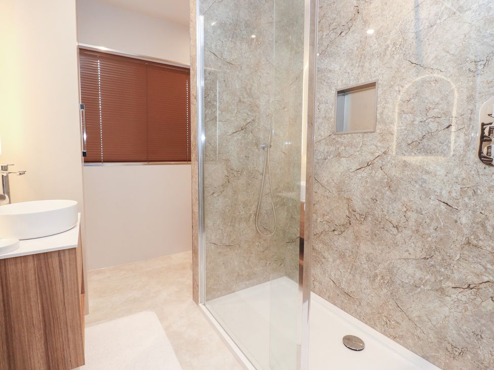 A bathroom with a shower and sink at 480 Marine Road East Morecambe