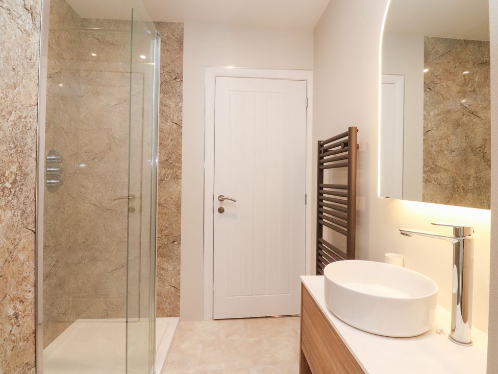 A bathroom with a shower and sink at 480 Marine Road East in Morecambe