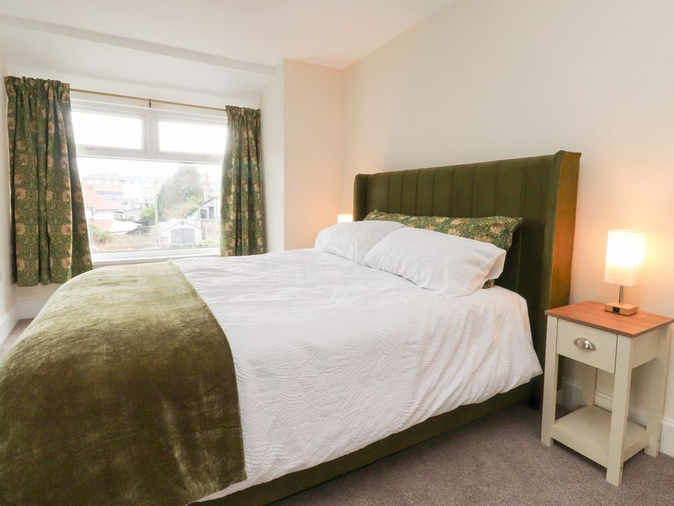 A bedroom with a bed and nightstand at 480 Marine Road East Morecambe