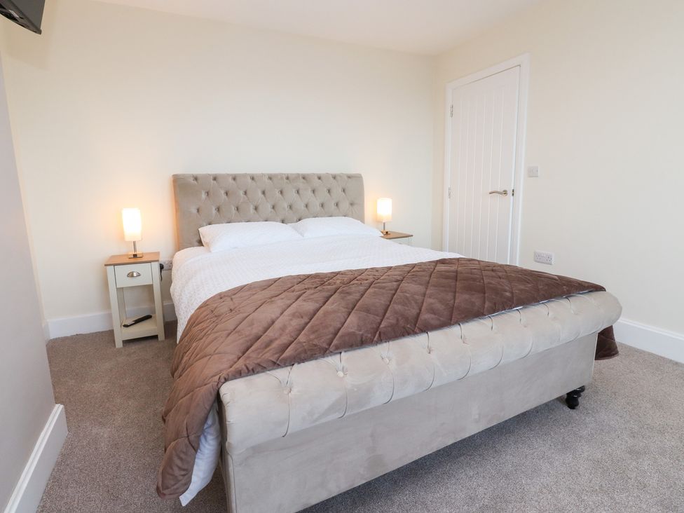 A bedroom with a bed and side table at 480 Marine Road East in Morecambe