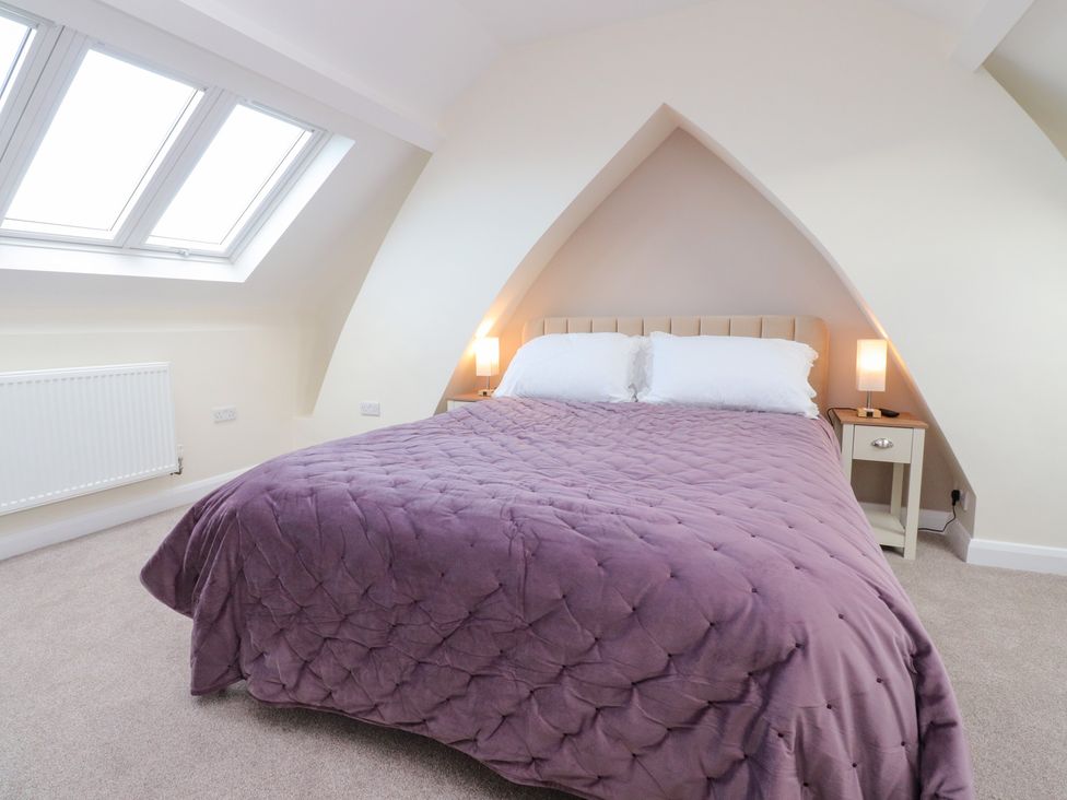A bedroom with a bed and bedside table at 480 Marine Road East in Morecambe