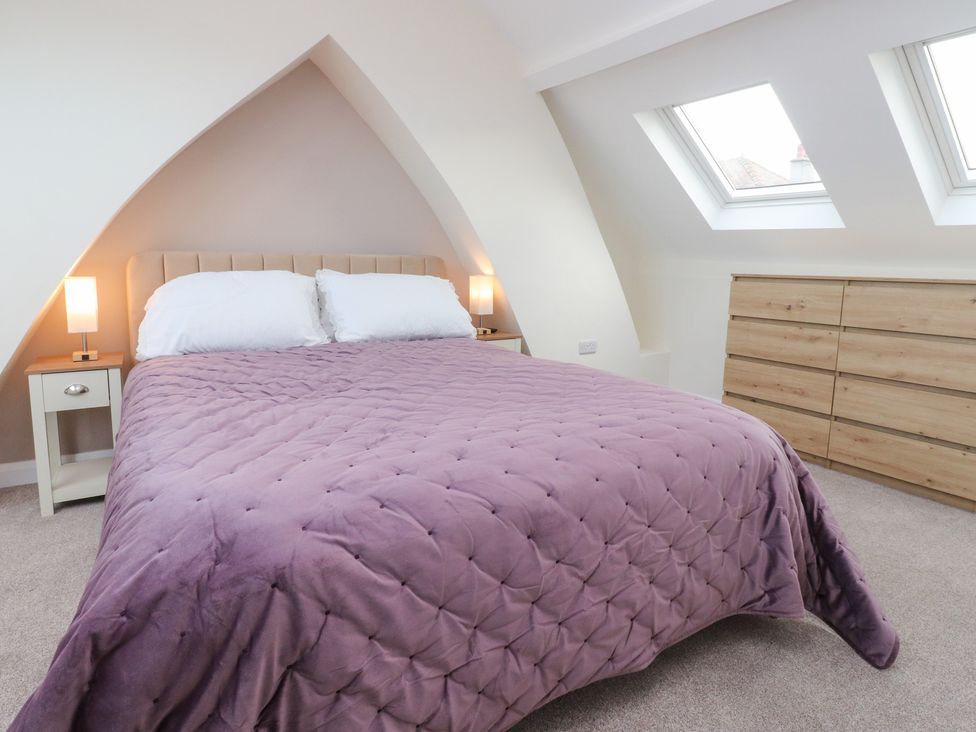 A bedroom with a bed and bedside table at 480 Marine Road East in Morecambe