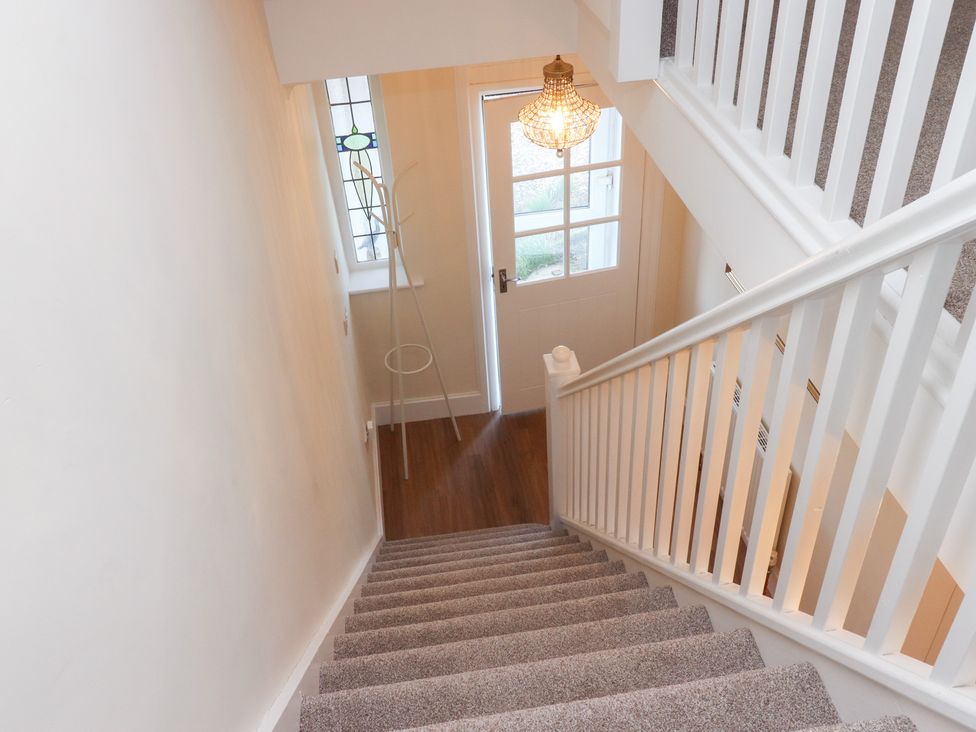A hallway with stairs and a door at 480 Marine Road East Morecambe