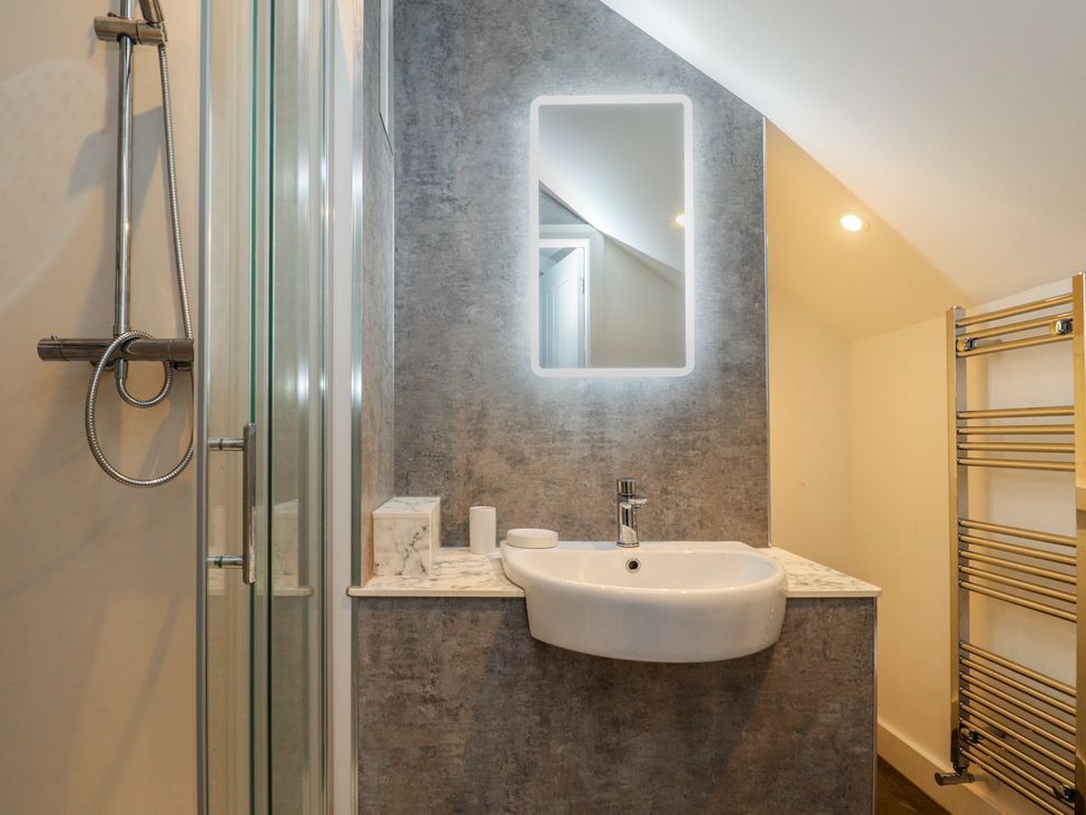 A bathroom with a shower and sink at Marilyn in Morecambe