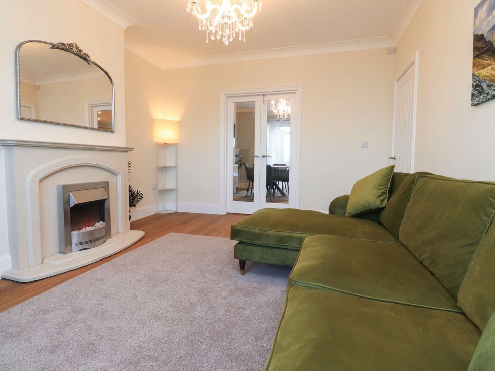 A living room with a sofa and fireplace at Marilyn in Morecambe