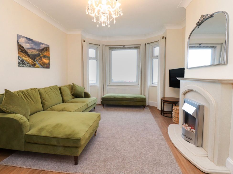 A living room with a sofa and television at Marilyn in Morecambe