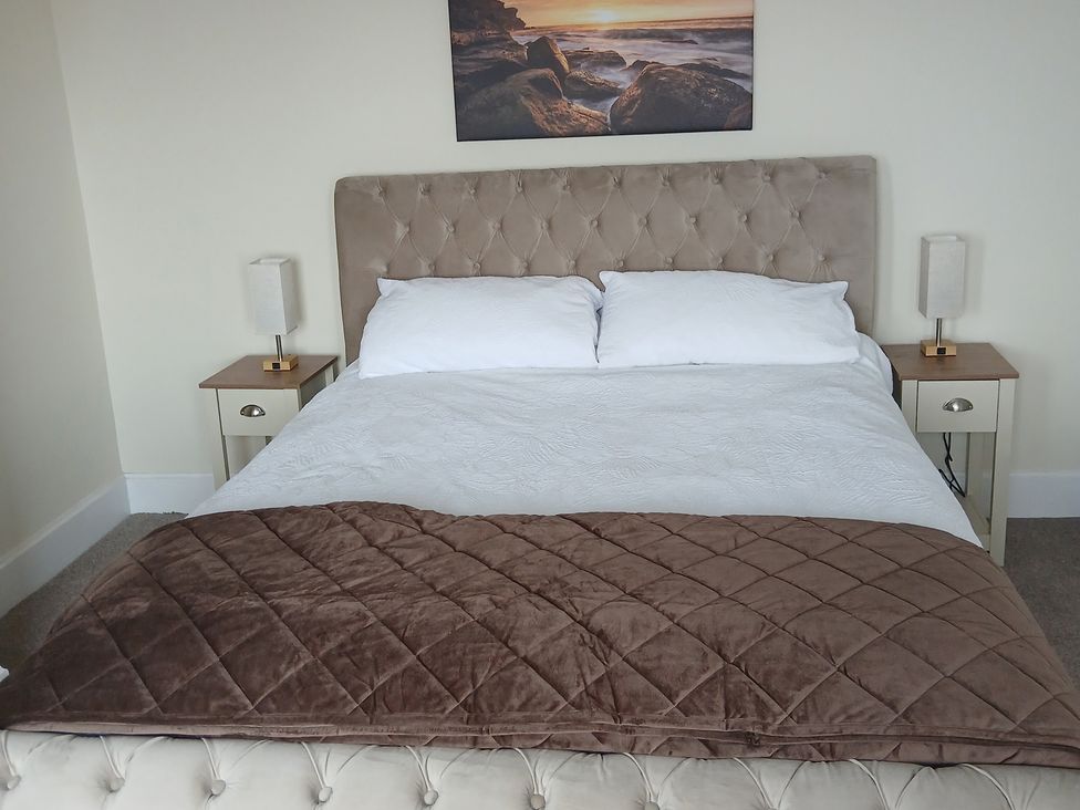 A bedroom with a bed and bedside tables at Marilyn in Morecambe