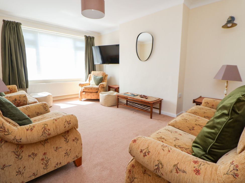 A living room with sofas and a coffee table at Bryn Bach in Rhos-On-Sea