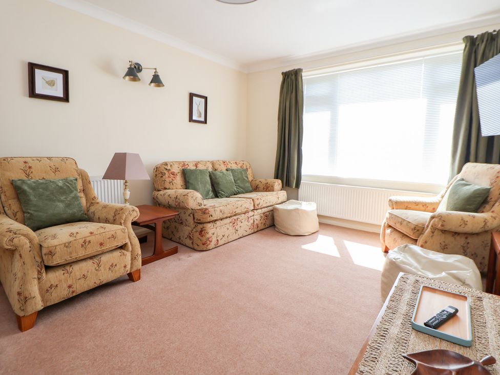 A living room with seating and a window at Bryn Bach in Rhos-On-Sea