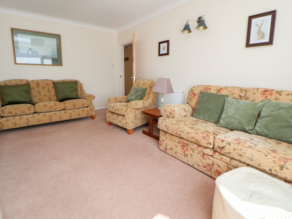 A living room with two sofas and an armchair at Bryn Bach in Rhos-On-Sea
