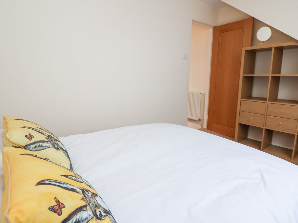 A bedroom with a bed and storage at Bryn Bach in Rhos-On-Sea