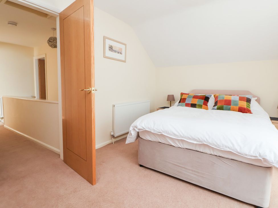 A bedroom with a bed and lamp at Bryn Bach in Rhos-On-Sea