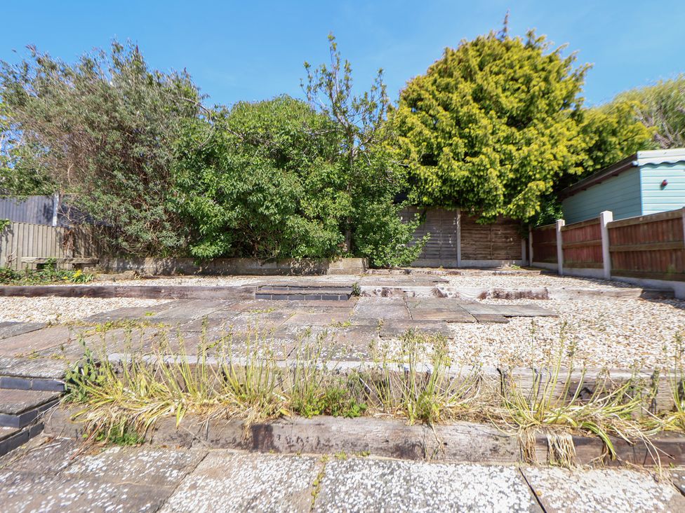 A garden with gravel and paving slabs at Bryn Bach in Rhos-On-Sea