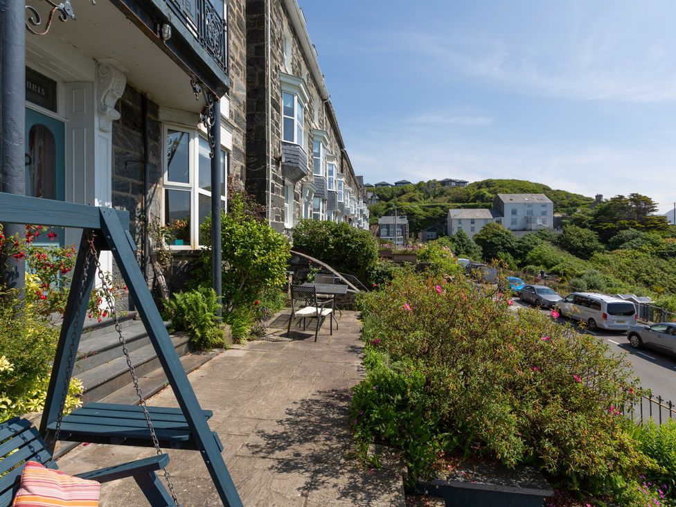 An outdoor area with a building and seating at Bod Idris in Barmouth