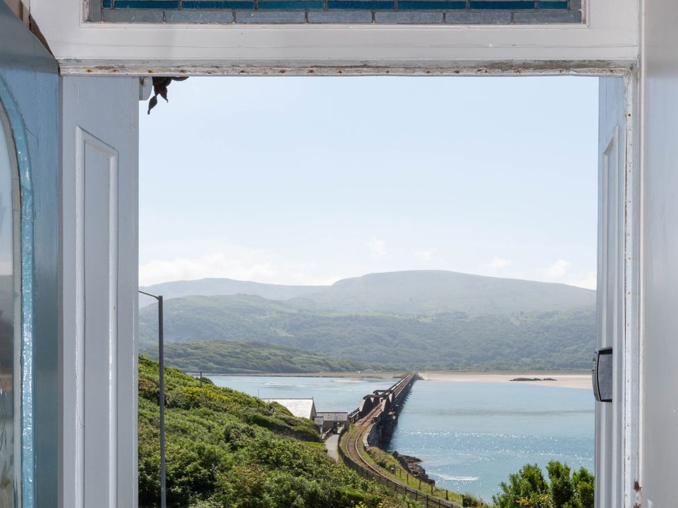 A view of mountains and water through a window at Bod Idris in Barmouth