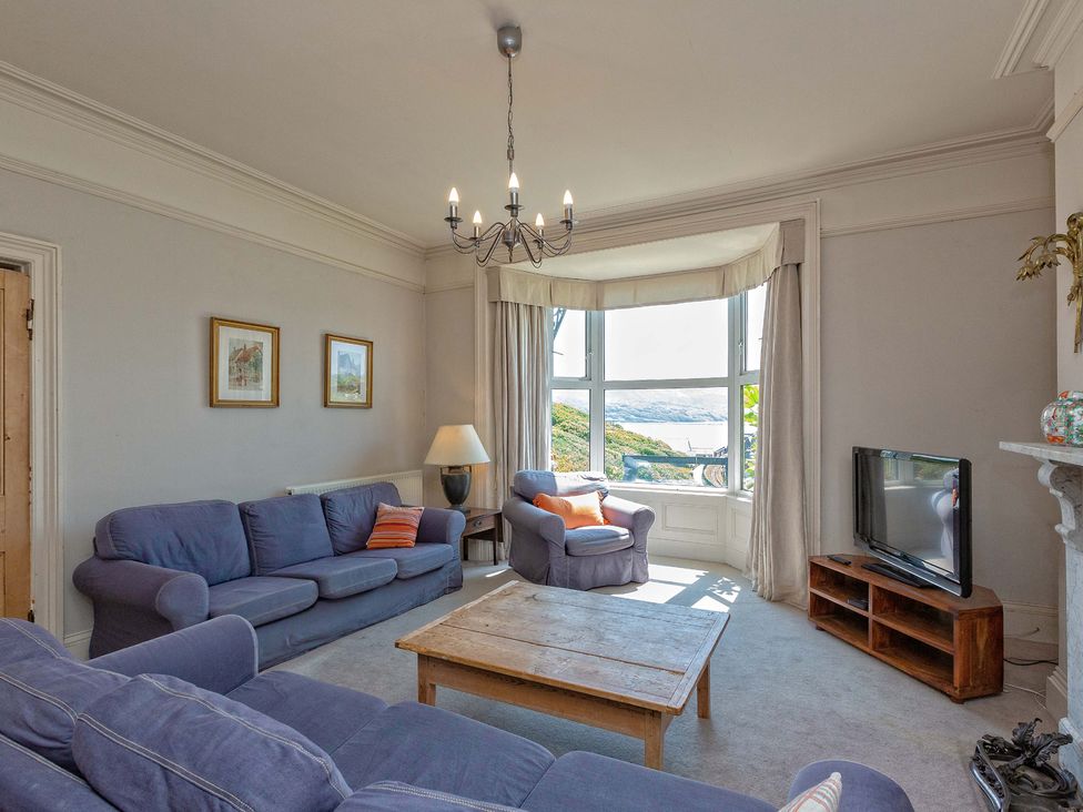 A living room with a sofa and television at Bod Idris in Barmouth
