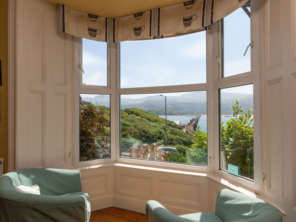 A living room with windows overlooking the landscape at Bod Idris in Barmouth