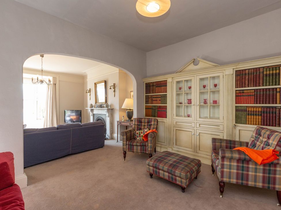A living room with a sofa and armchairs at Bod Idris in Barmouth