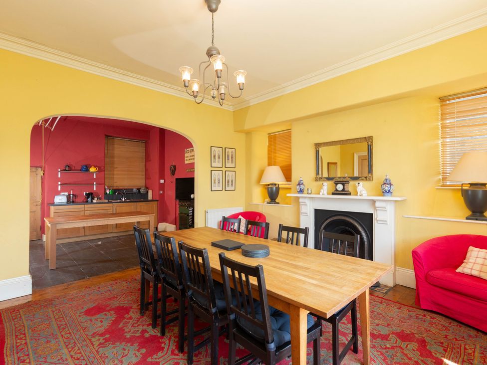A dining room with a large table and chairs at Bod Idris in Barmouth