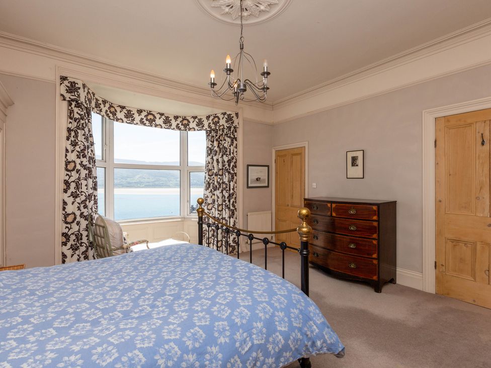 A bedroom with a bed and window view at Bod Idris in Barmouth