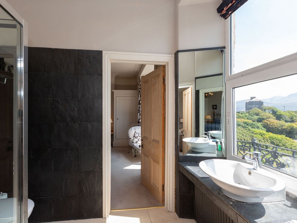 A bathroom with a sink and shower visible at Bod Idris in Barmouth