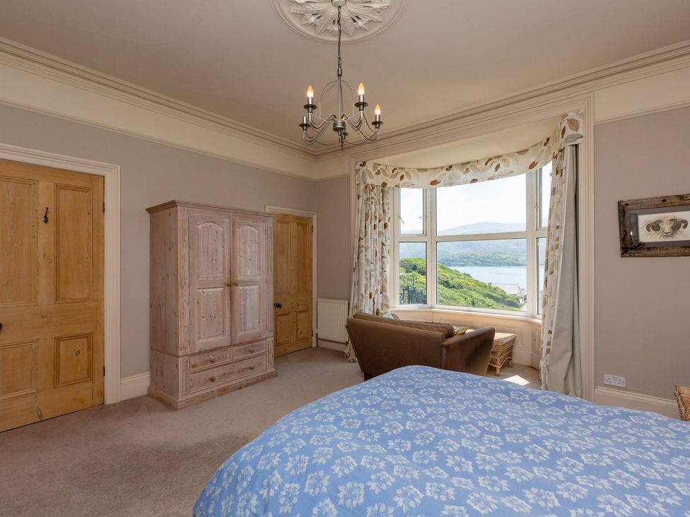 A bedroom with a bed and wardrobe at Bod Idris in Barmouth