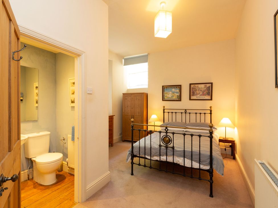 A bedroom with a bed and attached bathroom at Bod Idris in Barmouth