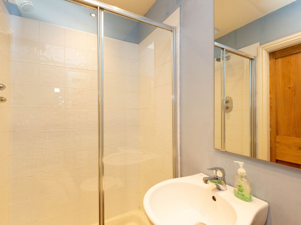 A bathroom with a shower and sink at Bod Idris in Barmouth