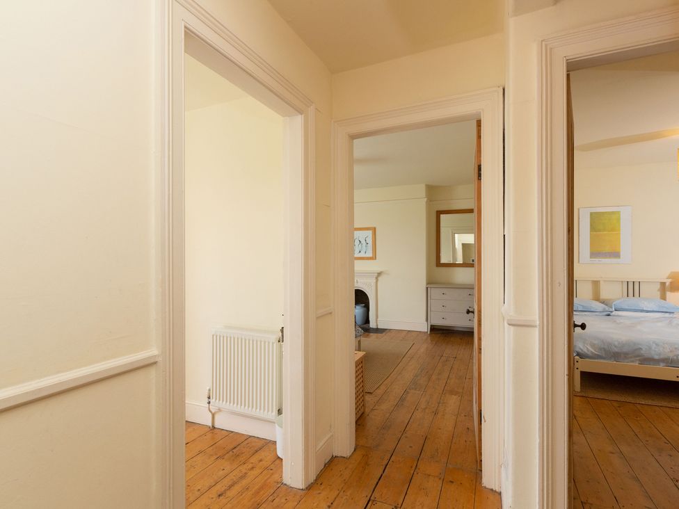 A hallway with doorways leading to rooms at Bod Idris in Barmouth
