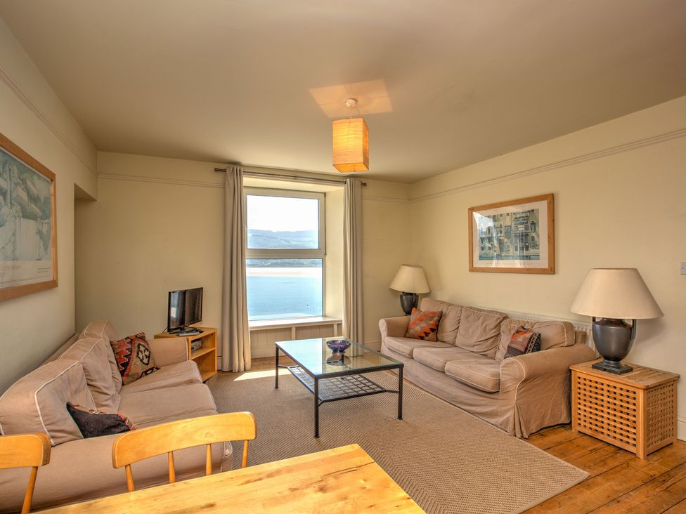 A living room with a sofa and table at Bod Idris in Barmouth