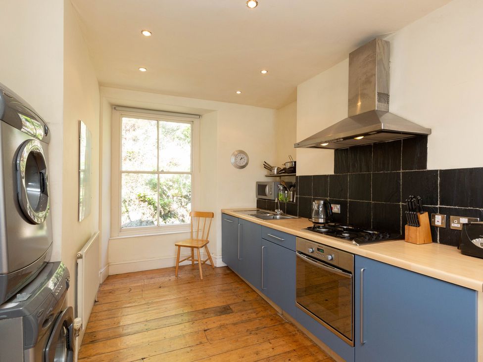 A kitchen with appliances and a window at Bod Idris in Barmouth