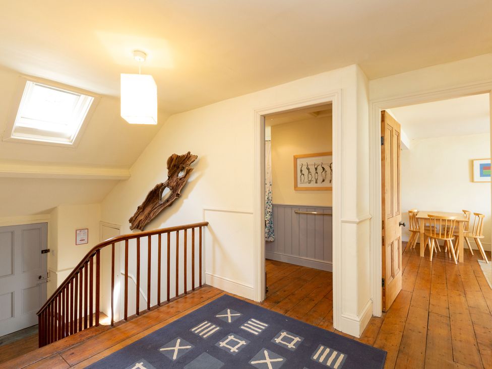 A hallway with stairs and doors at Bod Idris in Barmouth