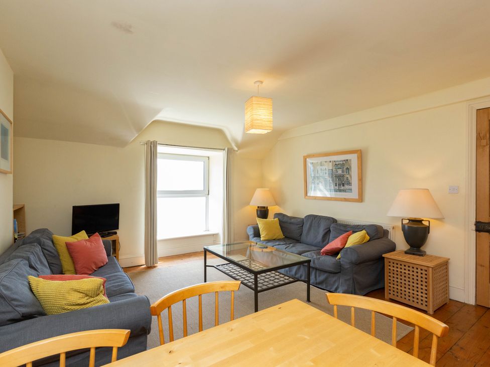 A living room with a sofa and coffee table at Bod Idris in Barmouth