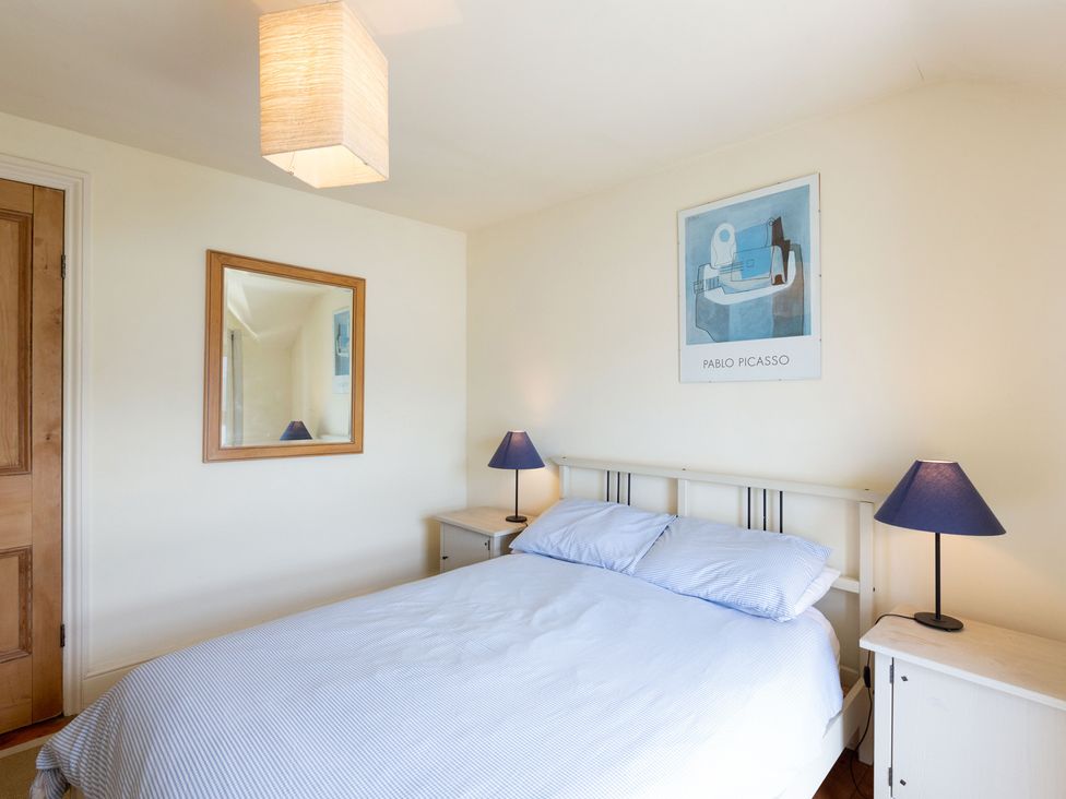 A bedroom with a bed and bedside tables at Bod Idris in Barmouth