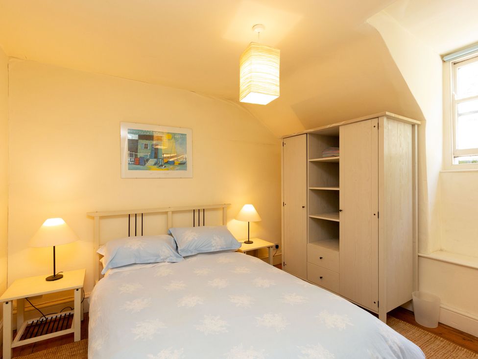 A bedroom with a bed and wardrobe at Bod Idris in Barmouth