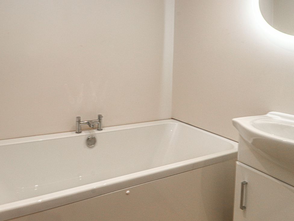 A bathroom with a bathtub and a sink at The Hideaway