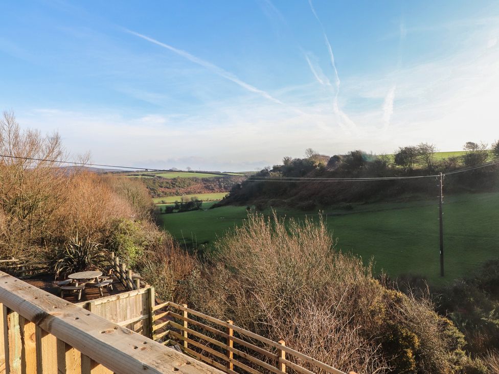 An outdoor view of a field with trees and a power line at The Hideaway in 