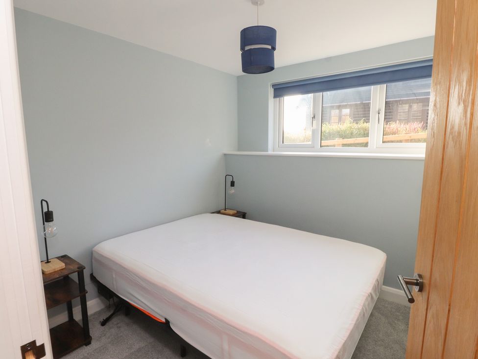 A bedroom with a bed and nightstand at The Hideaway in 