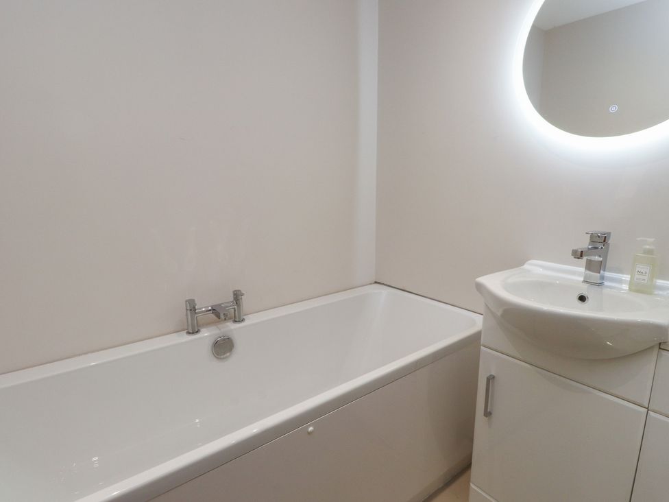 A bathroom with a bathtub and a sink at The Hideaway