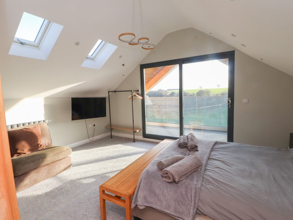 A bedroom with a bed and a television at The Hideaway